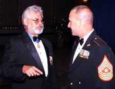 Vietnam War Medal of Honor recipient retired Army Sgt. Maj. Jon Cavaiani, left, chats with Marine Corps Sgt. Maj. Mark Allen