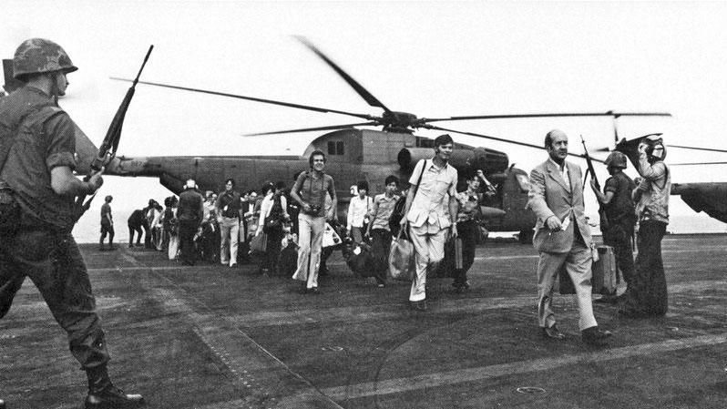 Evacuees from Vietnam aboard the flight deck of the aircraft carrier USS Midway (CVA-41) during "Operation Frequent Wind" in the South China Sea. The end of the Vietnam War, April 1975