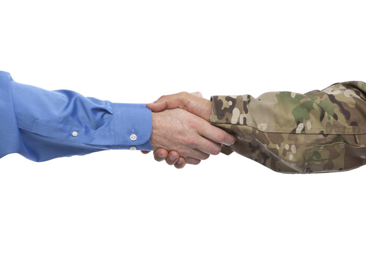 corporate hand shaking military hand