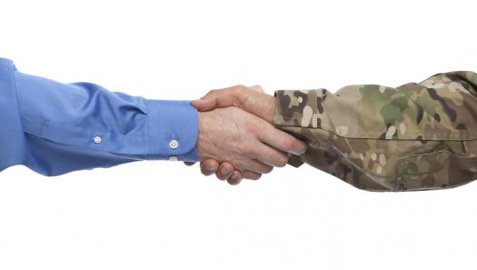 corporate hand shaking military hand