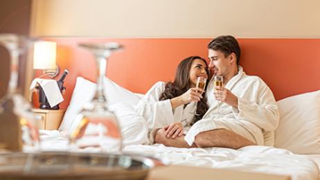 Wyndham hotels and resorts worldwide deal tile romantic couple on hotel bed
